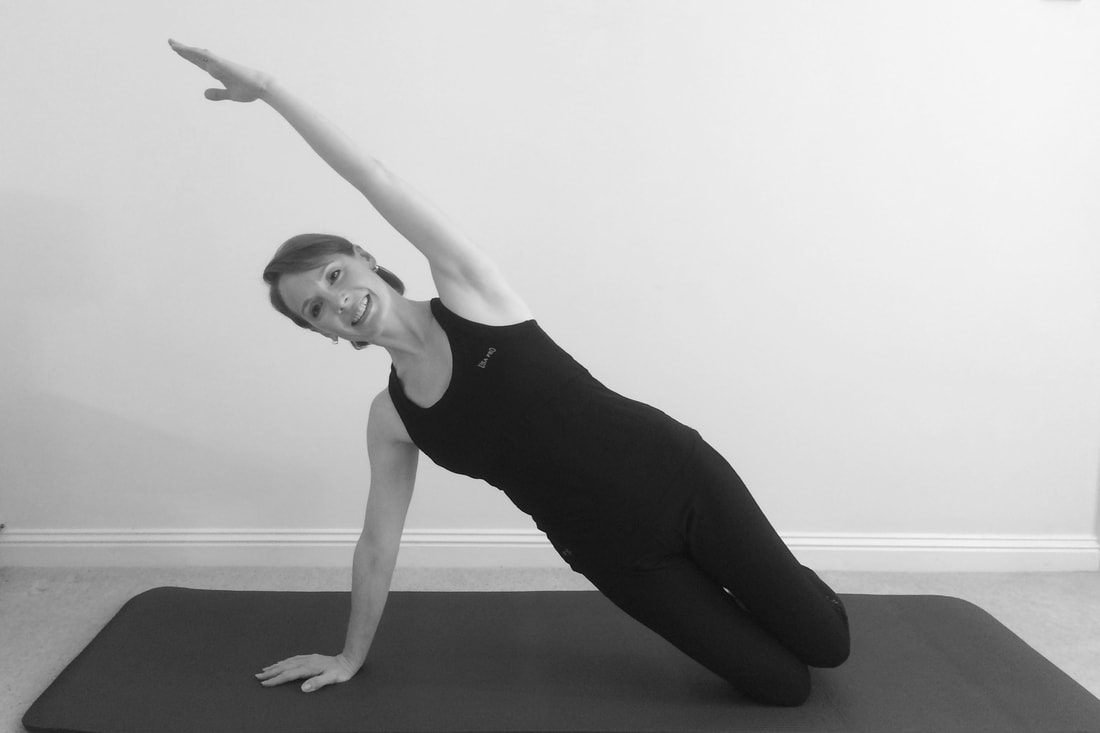 Owner of Worth Pilates performing a variation of side lift exercise in Balcombe, Sussex.