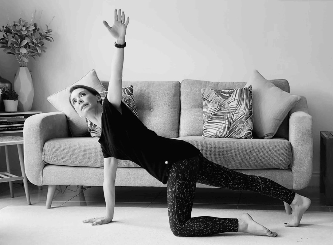 Worth Pilates Teacher demonstrating a kneeling rotation exercise during an Online Session