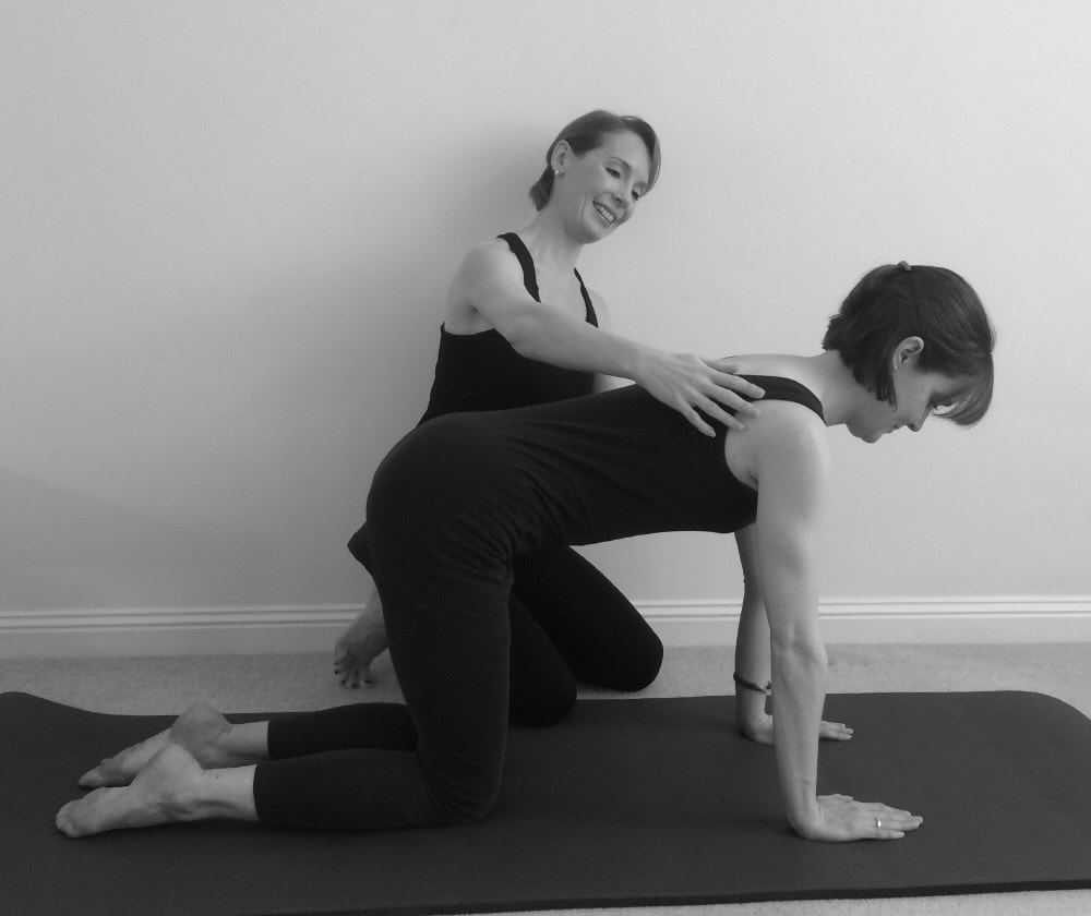 Worth Pilates Instructor teaching 4-point-kneeling posture in private Pilates session